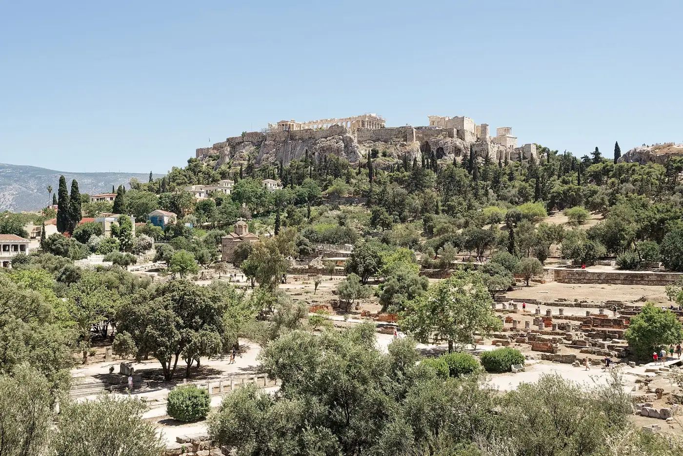 The Acropolis of Athens seen from the Ancient Agora, surrounded by greenery